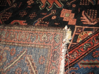 Antique Heriz 100% wool carpet, pre 1900.Beautiful natural colours:deep red,coral,indigo blue,cerulean blue against an inky midnight ground. Medallion centre. There are a few condition issues.Loss of fringe and a slight amount of  ...