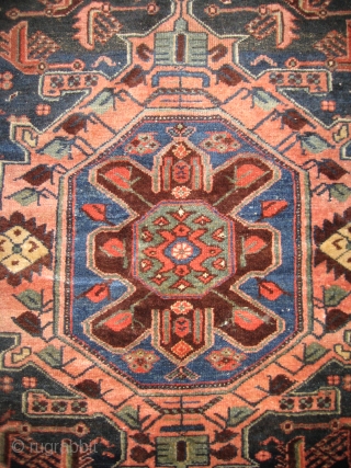 Antique Heriz 100% wool carpet, pre 1900.Beautiful natural colours:deep red,coral,indigo blue,cerulean blue against an inky midnight ground. Medallion centre. There are a few condition issues.Loss of fringe and a slight amount of  ...