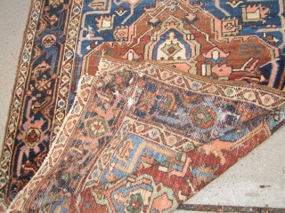 antique serapi heriz rug measuring 4' 11" x 6' 2" condition as shown one hole area of wear and scattered moth issue generally a good pile has been cleaned ends need work  ...