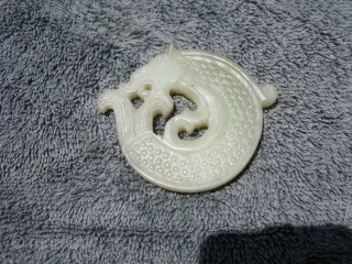 Vintage Chinese jade disc, hand carved water dragon, also called a dragon fish, king of all fishes, pale celadon, general good condition, the approximate size at the widest point is 3 inches  ...