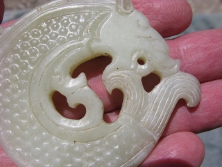 Vintage Chinese jade disc, hand carved water dragon, also called a dragon fish, king of all fishes, pale celadon, general good condition, the approximate size at the widest point is 3 inches  ...