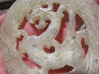 Vintage Chinese jade disc, hand carved foliate dragon, pale celadon, hairline crack but stable, the approximate size is 3.5 inches across, shipping is extra         