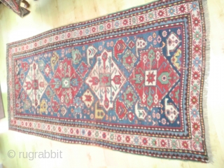 Pleasant Kazak. Good range of colours. Abrash. Interesting design. Slight losses one end, wear in the field in places and sides secured. But still bright and decorative. 199 by 100cm   