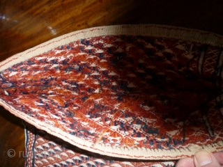 Sweet little Turkoman bag in white goat hair. All over motifs on front and back in red, rust and indigo. The second photo is the reverse. 36cm square. Couple of small repairs  ...