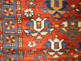 Pretty little 19th century kazak. Great colours and design. Losses to sides and edges. Couple of patches at back where rug is worn. Size 47 inches by 34.     