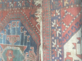 Pleasing kazak rug. Late 19th century with good abrash and asymetrical icons. Has a charm. Few small holes, small stain, tear on one end but pretty much untouched. Needs a good clean.  ...