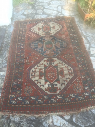 Pleasing kazak rug. Late 19th century with good abrash and asymetrical icons. Has a charm. Few small holes, small stain, tear on one end but pretty much untouched. Needs a good clean.  ...