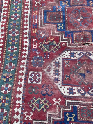 Dirty bashed up Kazak. Couplw of holes, rips and tears bur great colours and design. Ans despite its issues a great rug. Turkish repair special? 7 x 5 feet    