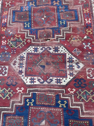 Dirty bashed up Kazak. Couplw of holes, rips and tears bur great colours and design. Ans despite its issues a great rug. Turkish repair special? 7 x 5 feet    