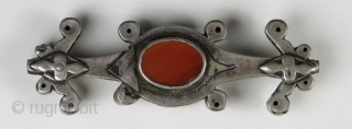 Turkmen Bead,  Silver with Carnelian, 1” x 3.5” Late 19th/Early 20th Century
There are silver triangles on both sides which appear to be old repairs.        