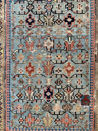 Early shirvan rug with powder blue field and Kufic border ca 1820 one old patch and darning to the corroded brown 
Not many rugs  this old on the market.    ...