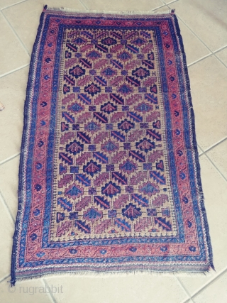 Antique Camel ground Baluch. Not a very common form of the ashik gul found in Baluch rugs. Nice grid work and notice how the arrows inside the guls point in one direction.  ...