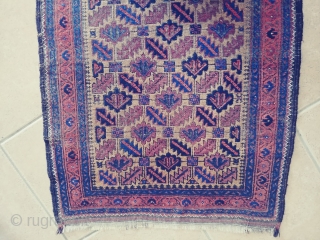 Antique Camel ground Baluch. Not a very common form of the ashik gul found in Baluch rugs. Nice grid work and notice how the arrows inside the guls point in one direction.  ...