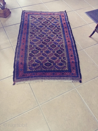 Antique Camel ground Baluch. Not a very common form of the ashik gul found in Baluch rugs. Nice grid work and notice how the arrows inside the guls point in one direction.  ...