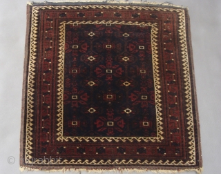 Square antique Baluch bagface with silk. I do not recall seeing bags with this  design having a running dog border nor could I find any in my library. Measures 2.3 inches  ...