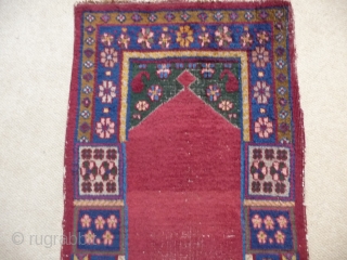 KHOTAN ;  An unusual Khotan prayer rug, complete and in reasonable condition.
SOLD                    