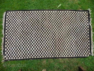  SOLD  Tibetan checkerboard rug, collected in Tibet in the early 20th c. interesting provenance, small damage to two corners otherwise good condition,5ft3in x 2ft11in.       