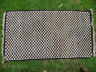  SOLD  Tibetan checkerboard rug, collected in Tibet in the early 20th c. interesting provenance, small damage to two corners otherwise good condition,5ft3in x 2ft11in.       