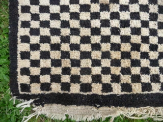  SOLD  Tibetan checkerboard rug, collected in Tibet in the early 20th c. interesting provenance, small damage to two corners otherwise good condition,5ft3in x 2ft11in.       