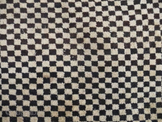  SOLD  Tibetan checkerboard rug, collected in Tibet in the early 20th c. interesting provenance, small damage to two corners otherwise good condition,5ft3in x 2ft11in.       