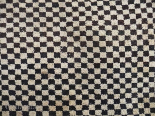  SOLD  Tibetan checkerboard rug, collected in Tibet in the early 20th c. interesting provenance, small damage to two corners otherwise good condition,5ft3in x 2ft11in.       