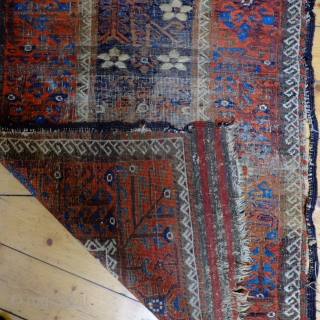 An early Mina Khani Persian Baluch Rug 
Size 215 x 91 cm
In distressed fragmented condition with wonderful colours, including an electric blue and aubergine brown and dating from the mid 19th century.  ...