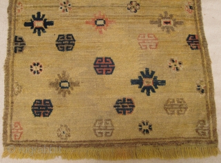 Mid 19th century Tibetan Prayer rug in Ningxia yellow, size 84cm x 141cm, Fringes on both ends are not original there are three small repairs in the field. Pile wear to centre.  ...