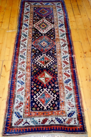  A 19th Century South Caucasian/Northwest Persian Long Rug
 Size 299 x 108 cm

A transitional Caucasian/Northwest Persian long rug with very good colours and with original knotted fringes at one end, original  ...