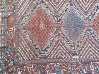 Attractive antique Khamseh with vibrant colours. Partially low pile and a small area with a reparation and a very small hole (see last two photos). Size is 220 x 153 cm.  