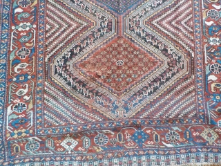 Attractive antique Khamseh with vibrant colours. Partially low pile and a small area with a reparation and a very small hole (see last two photos). Size is 220 x 153 cm.  