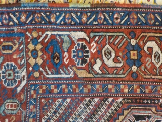 Attractive antique Khamseh with vibrant colours. Partially low pile and a small area with a reparation and a very small hole (see last two photos). Size is 220 x 153 cm.  