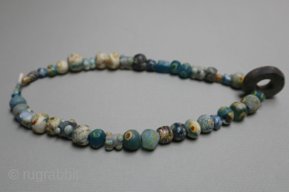 Ancient mosaic glass, stone and mother of pearl necklace, Caucasus or Asia Minor, 2nd-1st centuries BCE, restrung, 42cm long.              