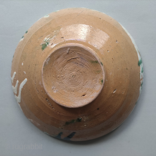 A Samanid splashware bowl
Samarkand, 10th century
Of conical form on short foot with straight lip, the sgraffiato decoration with a large, stylised flower with two leaves, with yellow and green splashes and clusters  ...