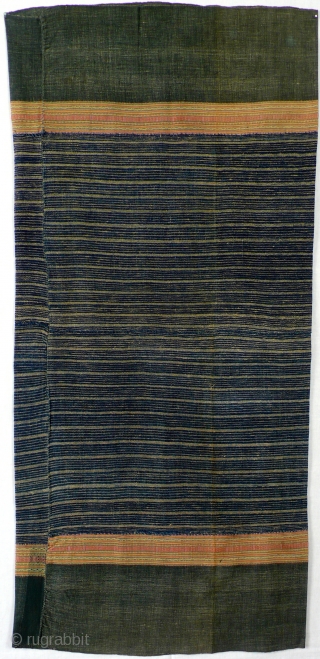  Woman's skirt, handwoven, Thailand, ca. 1950

Handspun, handwoven cotton, indigo dyed, 4 panels, minimalistic design with plain off white stripes, complementary warp stripes in light colours on both sides.

Condition: slightly faded, some  ...