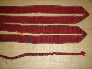 Early 20th Century, Wool, Turkmen Tentband (likely Tekke) with Wooden Wishbone-shaped Fastener. Colour: Deep Red and Black. 
Strap Length (without Rope Fastener): Approx. 997cm ; Strap Width: Approx. 09cm.
Rope Fastener Length (one  ...