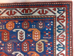 Antique Kazak rug in an indigo blue ground with polychrome boteh / buta motifs.  ~1880-90. 102x170cm (3'4"x5'6"). Rare natural colors which can not be seen in late examples - apricot, emerald  ...