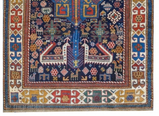 Antique Shirvan "Akstafa" bird/peacocks rug, ~1870. Size: 117x260cm (3'10"x8'6"). The dark blue indigo field with three blue, ivory and red octagonal star medallions, each containing different motifs such as hooked swastika, diamond  ...