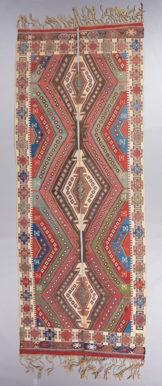 An early Anatolian Kilim in great condition woven in two panels. Great colors, great border,and rare to see one with the tassels fully intact. Quite fine as well. It has bits of  ...