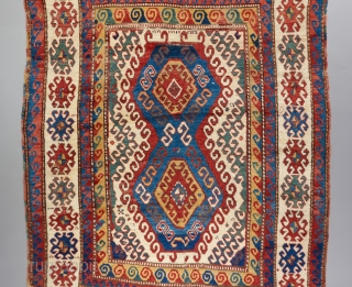 Bold Kazak with superb color and very good age. Much of it in fluffy sumptuous pile. Cut and sewn back together in a few places but only missing a very small amount  ...