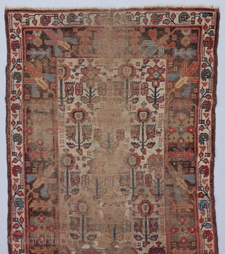 Circa 1800 Kurdish rug with a beat up but beautiful field of three different flower forms. Great scale in the drawing. 6’8” x 3’10”.         