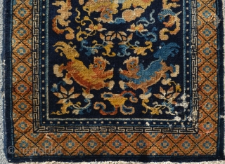 Well composed Chinese mat with Foo Dogs, floral designs, cloudbands and a fish that's placed neatly into one of the cloudbands. Nice soft wool and Good condition except for one area of  ...