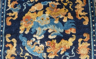 Well composed Chinese mat with Foo Dogs, floral designs, cloudbands and a fish that's placed neatly into one of the cloudbands. Nice soft wool and Good condition except for one area of  ...