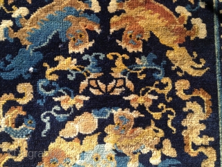 Well composed Chinese mat with Foo Dogs, floral designs, cloudbands and a fish that's placed neatly into one of the cloudbands. Nice soft wool and Good condition except for one area of  ...