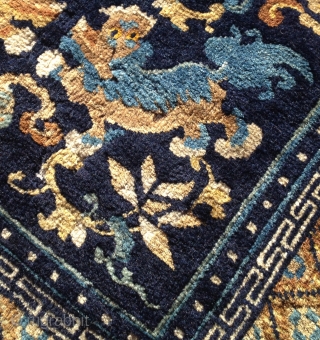 Well composed Chinese mat with Foo Dogs, floral designs, cloudbands and a fish that's placed neatly into one of the cloudbands. Nice soft wool and Good condition except for one area of  ...