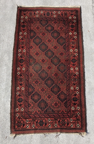 Baluch rug with a dignified presence . Precise drawing and very good color. Good condition with some wear and corrosion.             