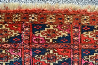 Turkmen. One jumbled up repair and wear and tear. Pink silk highlights in every other gol compartment.  Yellow silk highlights in some of the secondary motifs around the gols that are  ...