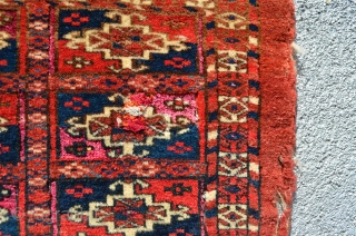 Turkmen. One jumbled up repair and wear and tear. Pink silk highlights in every other gol compartment.  Yellow silk highlights in some of the secondary motifs around the gols that are  ...