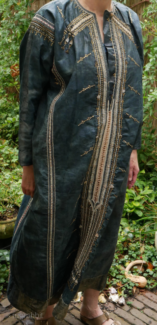 Rare Yemen bridal or festive dress (zanna) made of indigo dyed cotton, decorated with a variety of small, applied metal discs, metal chains, pieces of shell, as well as various embroidery stitches.  ...