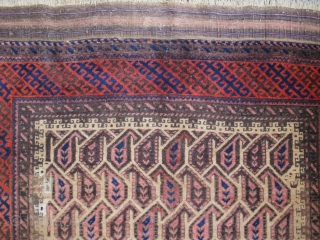 Very graphic camel ground Baluch rug with unusual geometric botehs arranged in a subtle but sophisticated repeat, creating diagonal negative space that works very well with the diagonal latch-hook striped border. The  ...
