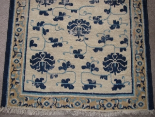 Sweet White-Ground Chinese Ningxia Rug, blue peonies and arabesque with a minimal border. hand-spun cotton warp and weft. very soft wool pile. size is 3'6"x5'7".        